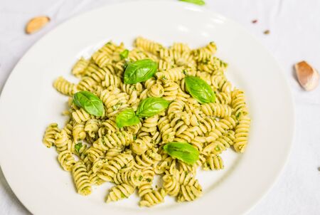Pasta with basil and cheese pesto against white backgroundの写真素材