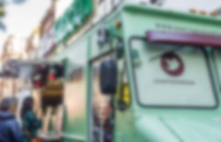 People at a street food market festival on a sunny day, blurred on purposeの写真素材