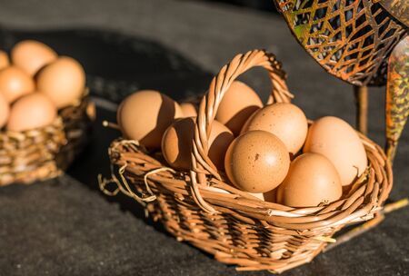Chicken eggs in a basket at a street food marketの写真素材