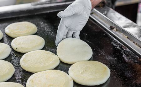 Raw uncooked arepas, traditional Colombian dish, at a street food marketの写真素材