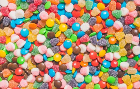 Assortment of sweet dessert colorful gummi jelly and chocolate candyの写真素材