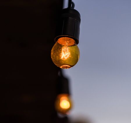 Vintage antique hanging light bulbs. Holidays and business good idea concept.の写真素材