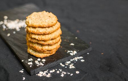 Peanut butter oatmeal cookies against black backgroundの写真素材