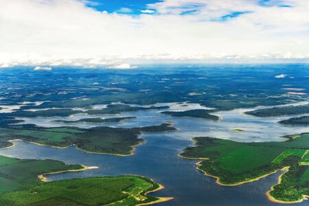 Landscape aerial view of colorful Amazon rivers, forest, jungle, and fieldsの写真素材