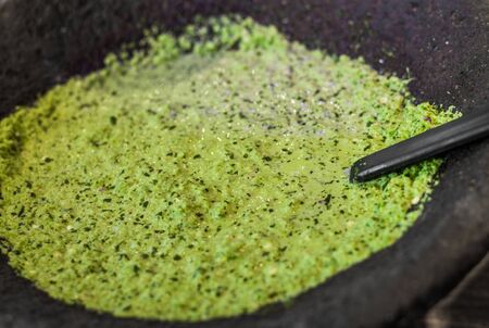 Traditional Mexican hot and spicy green salsa in a bowl.