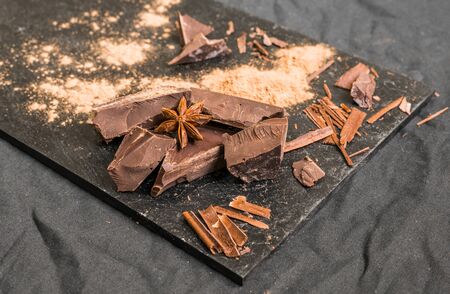 Chocolate with chocolate chips against black background.の写真素材