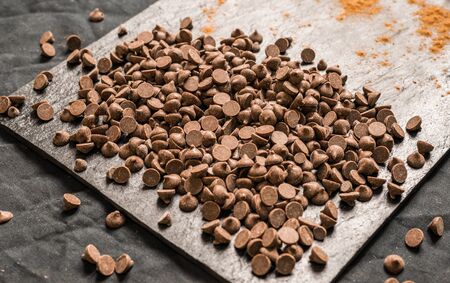 Chocolate with chocolate chips against black background.の写真素材
