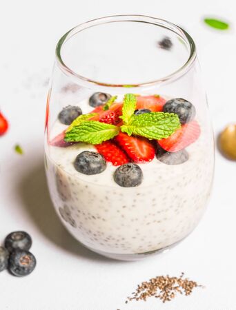 Breakfast yoghurt with chia seeds against white background.の写真素材