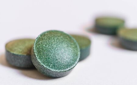Spirulina pills tablets macro photo against white background.の写真素材