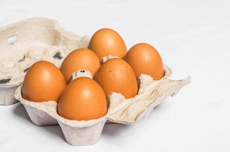 Fresh chicken eggs against white and blue background.の写真素材