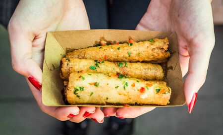 Deep fried spring rolls, Chinese cuisine staple, at a street food market.の写真素材
