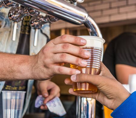 Serving cold beer at a street food market.