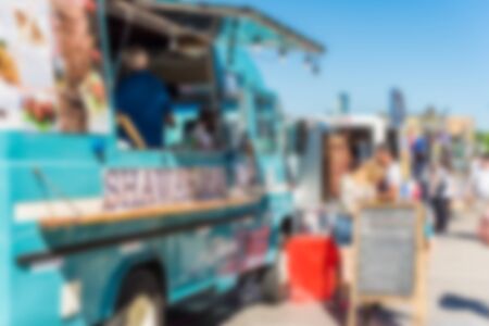 People at a street food market festival on a sunny day. Blurred on purpose.の写真素材