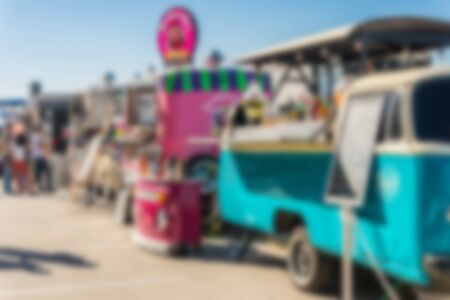 People at a street food market festival on a sunny day. Blurred on purpose.の写真素材