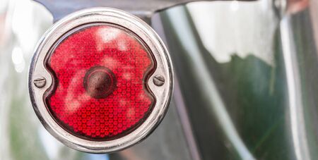 Rear light of a vintage retro old car automobile vehicle.