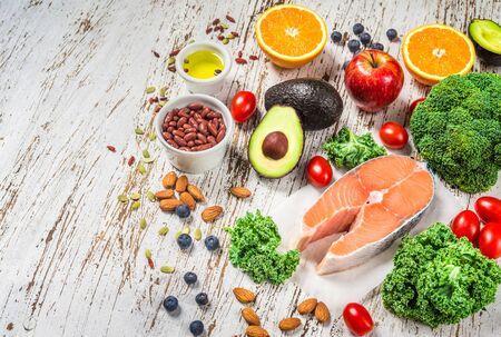 Selection of fresh fruit and vegetables, salmon, beans, and nuts.の写真素材