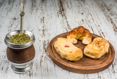 Traditional Argentinian yerba mate tea in calabash gourd and argentine pastries.の写真素材