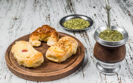 Traditional Argentinian yerba mate tea in calabash gourd and argentine pastries.の写真素材