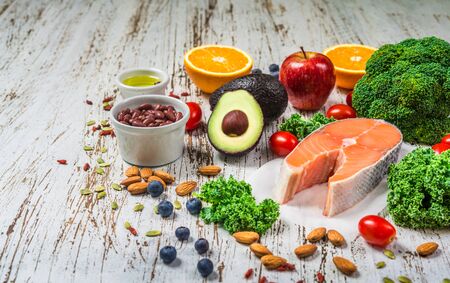 Selection of fresh fruit and vegetables, salmon, beans, and nuts.の写真素材