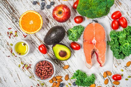Selection of fresh fruit and vegetables, salmon, beans, and nuts.の写真素材