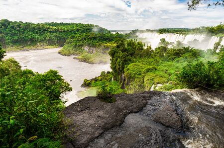 Wide angle landscape view of Iguazu falls waterfalls on a sunny day in summer.の写真素材
