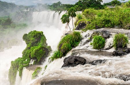 Wide angle landscape view of Iguazu falls waterfalls on a sunny day in summer.の写真素材