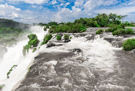 Wide angle landscape view of Iguazu falls waterfalls on a sunny day in summer.の写真素材