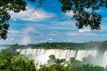 Wide angle landscape view of Iguazu falls waterfalls on a sunny day in summer.の写真素材