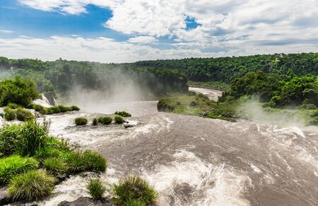 Wide angle landscape view of Iguazu falls waterfalls on a sunny day in summer.の写真素材