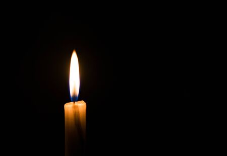 Candle light flame. Concept of memory, remembrance, mourning, grief, and sorrow.の写真素材