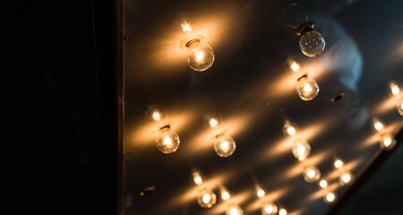 Vintage antique hanging light bulbs at a street food market.の写真素材