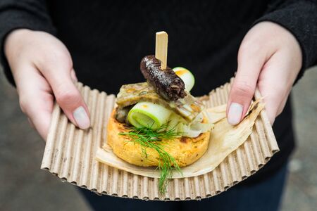 Arepa, Colombian corn patties, with blood sausage, head cheese, and zucchini.の写真素材