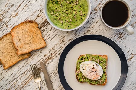 Avocado toast with poached egg. Vegetarian food and healthy eating concept.の写真素材