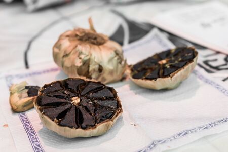 Close up of organic black garlic on display at a street food market.の写真素材