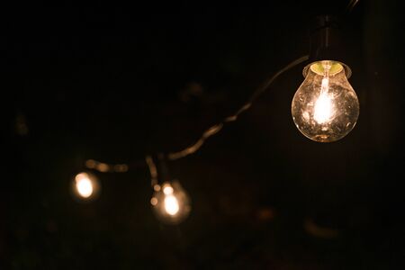 Vintage antique hanging light bulbs at a street food market.の写真素材