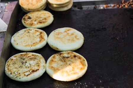 Arepas, Colombian corn patties filled with cheese, at a street food marketの写真素材