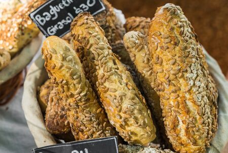 Freshly baked baguette bread loaves at a street food market fair festival.