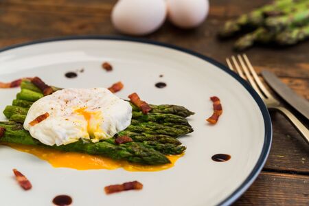 Food photography of a poached egg with asparagus, and crispy baconの写真素材
