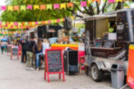 Food trucks at a street food market, blurred on purposeの写真素材
