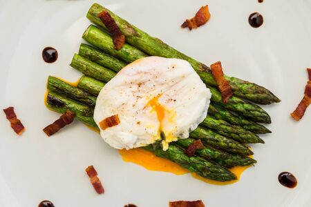 Food photography of a poached egg with asparagus, and crispy baconの写真素材