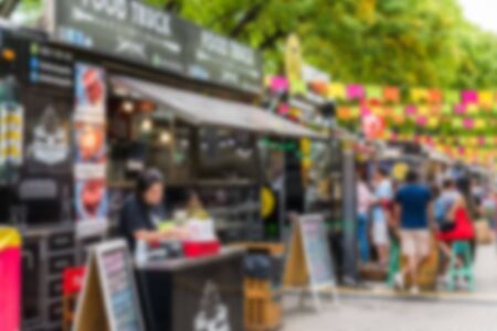 Food trucks at a street food market, blurred on purposeの写真素材