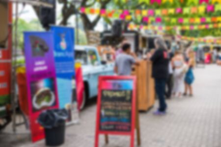 Food trucks at a street food market, blurred on purposeの写真素材