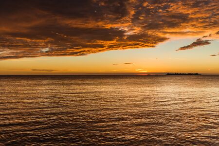 Landscape nature of sunset sky at the beach and colorful shiny sea oceanの写真素材