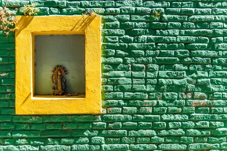 Colorful yellow vintage retro window and green brick wall of old house buildingの写真素材