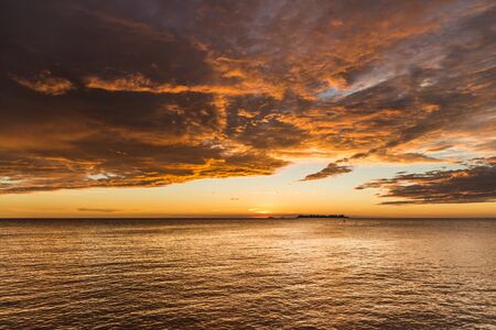 Landscape nature of sunset sky at the beach and colorful shiny sea oceanの写真素材