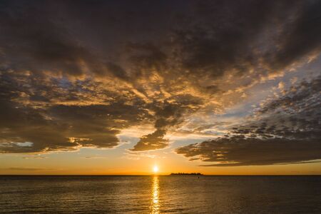 Landscape nature of sunset sky at the beach and colorful shiny sea oceanの写真素材