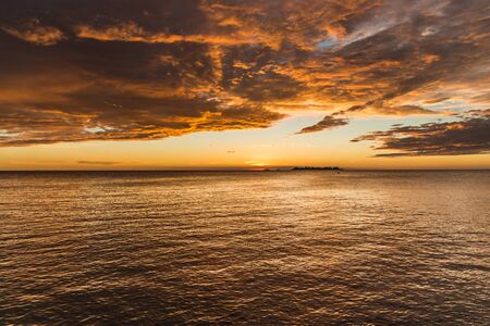 Landscape nature of sunset sky at the beach and colorful shiny sea ocean.の写真素材