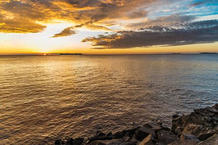 Landscape nature of sunset sky at the beach and colorful shiny sea oceanの写真素材