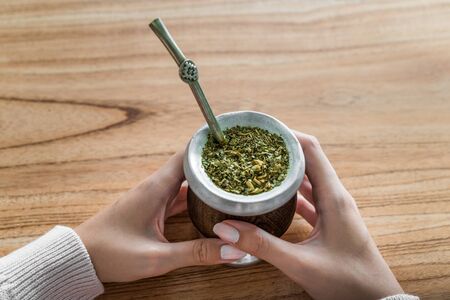 Young woman drinking traditional Argentinian yerba mate tea