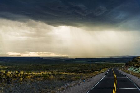 Background of rain, dark clouds, steppes, and mountains in Patagonia, Argentinaの写真素材